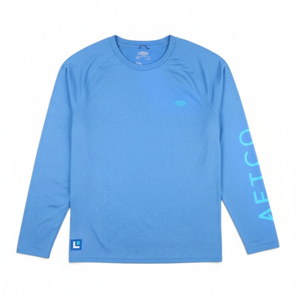 Front view of a blue performance long‑sleeve shirt featuring an AFTCO fish logo on the chest and Lowrance branding on the left sleeve.