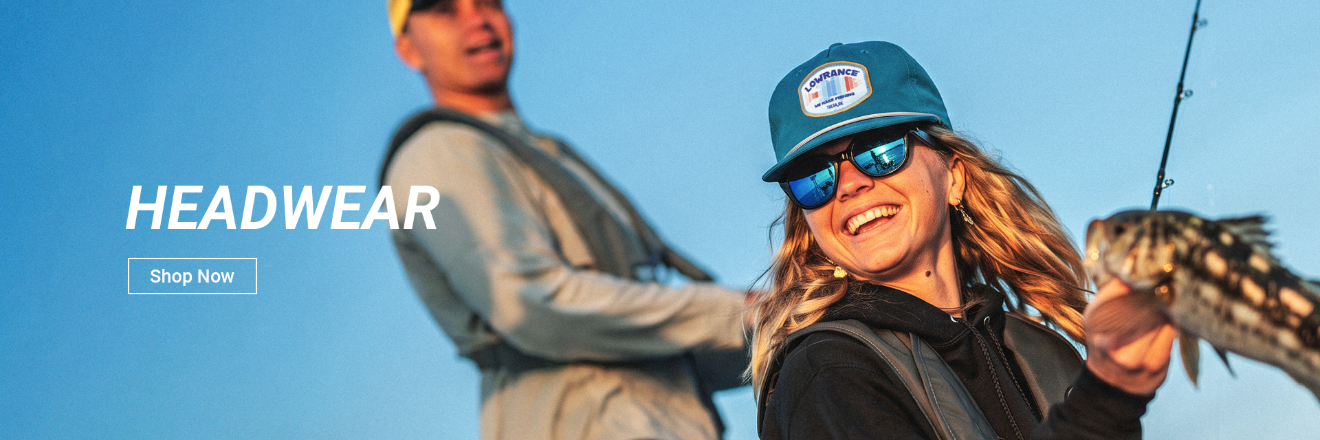 Two people wearing Lowrance hats with HEADWEAR text and Shop Now Button overlay